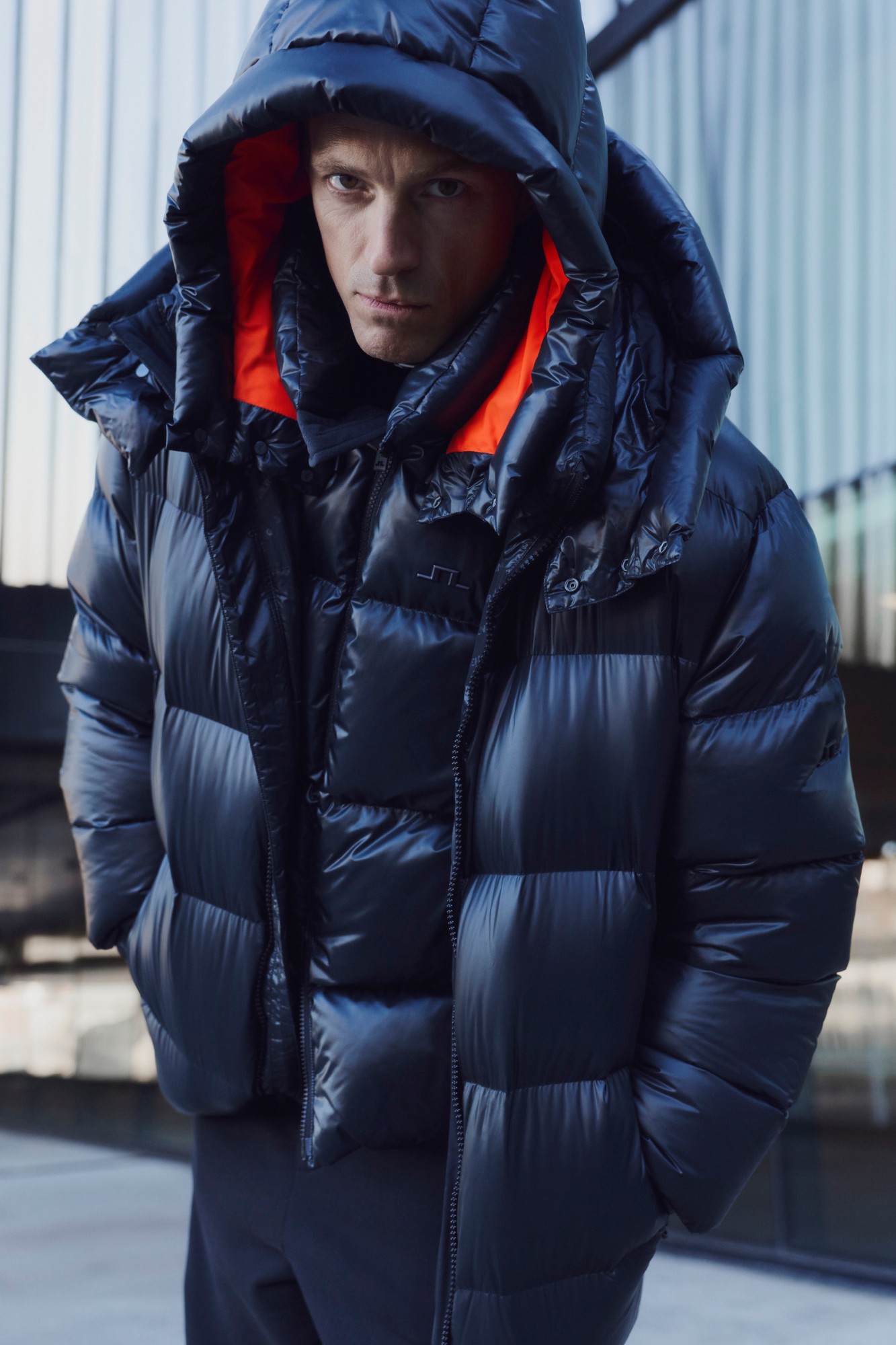 Joel Kinnaman in a hooded black puffer jacket